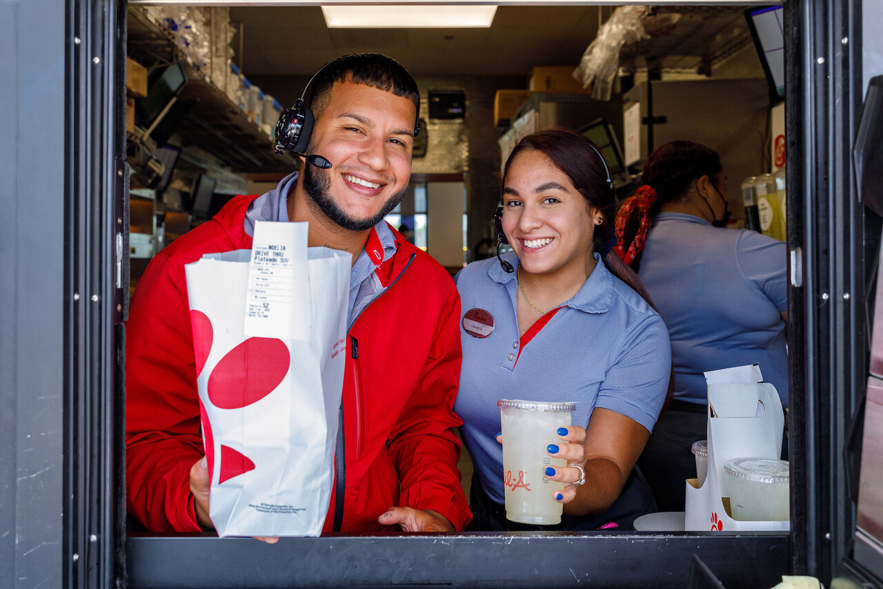 Team Members smiling in the drive thru window