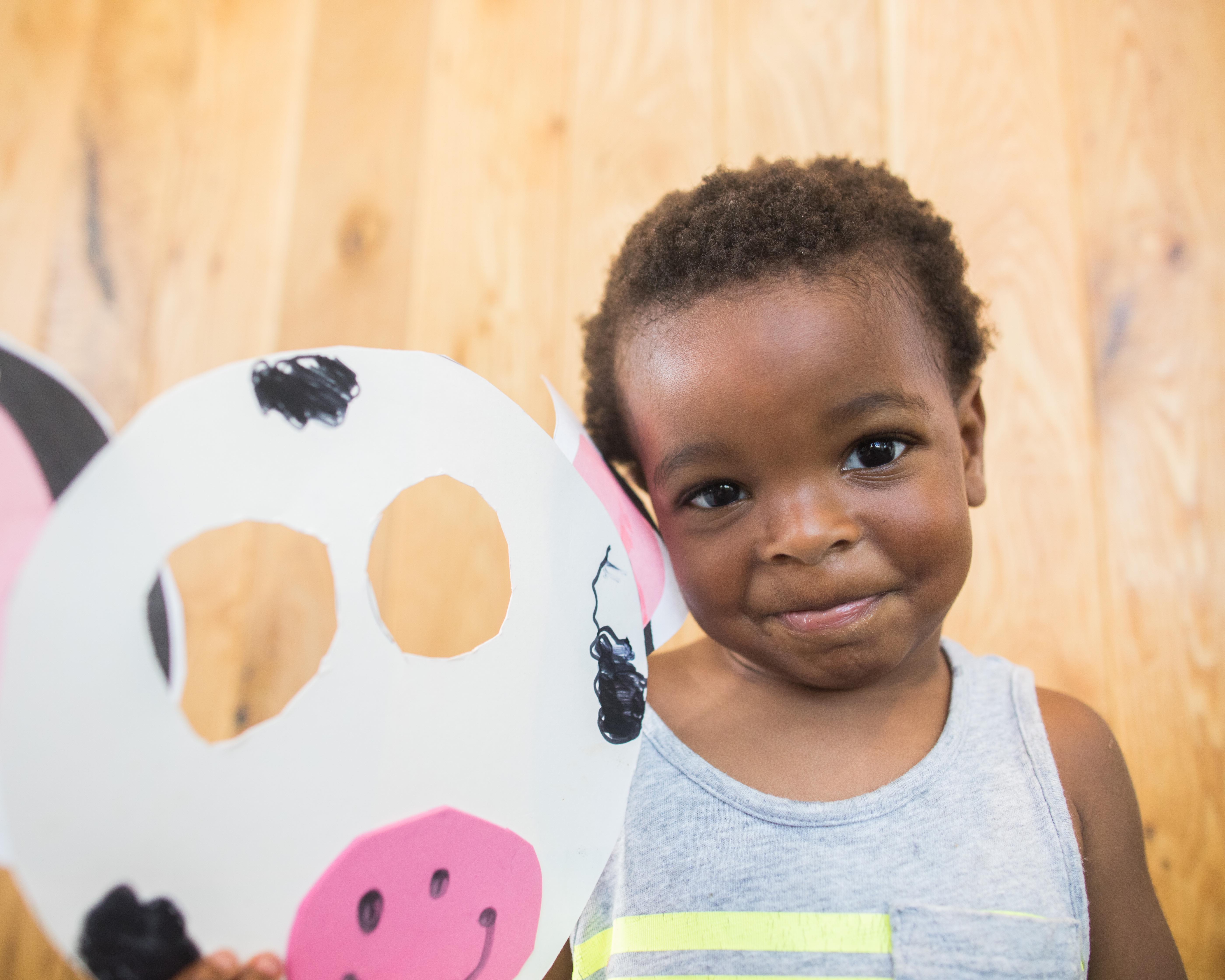 A Chick-fil-A Guest holding a handmade cow face mask.